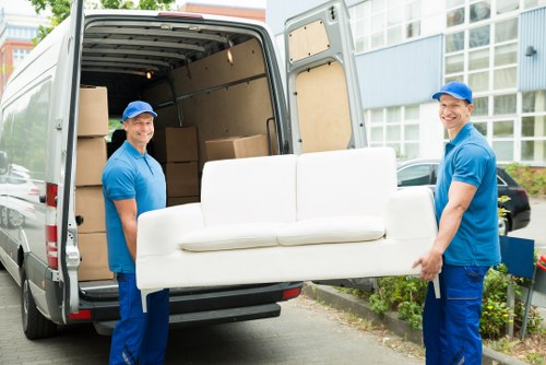 Van moving service with items being loaded carefully