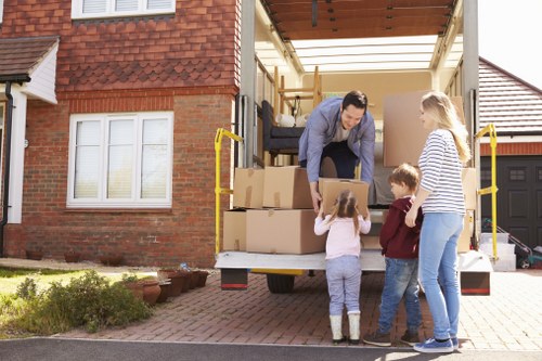 Workers preparing a van load safely with protective equipment