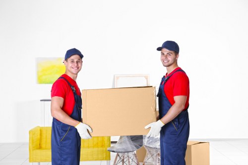 Packing boxes and furniture for a moving truck in Camdentown