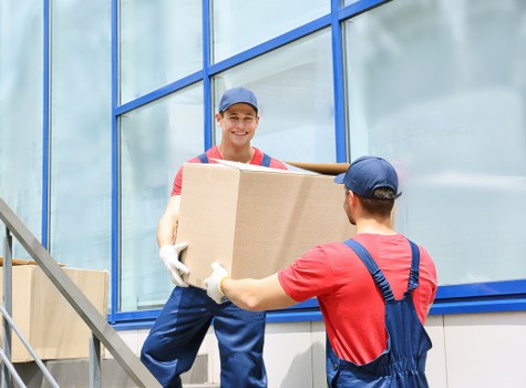 Moving team preparing furniture safely with protective equipment