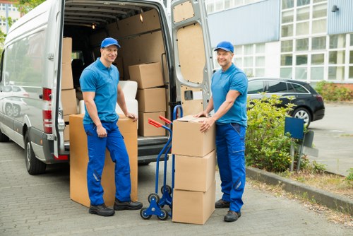 Removal van and household boxes ready for loading
